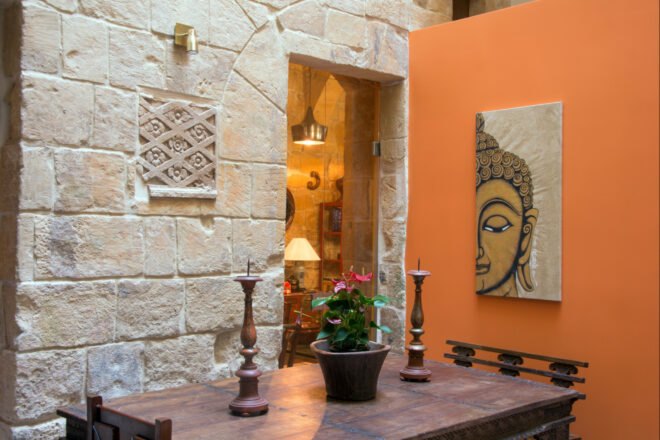 room with stone walls and Buddha art