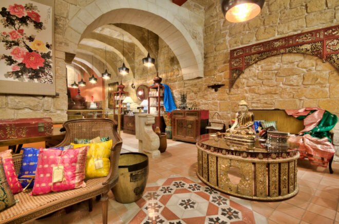 interior of hotel with stone walls and arched doorways