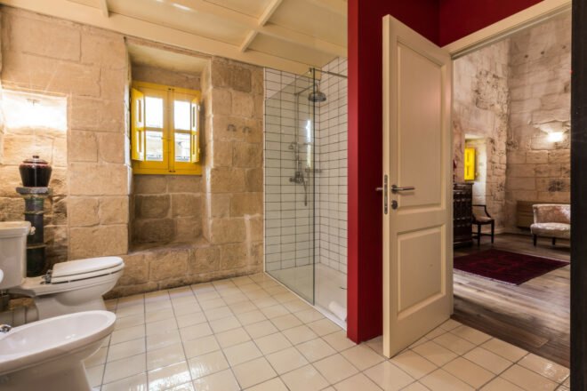 large bathroom with stone wals