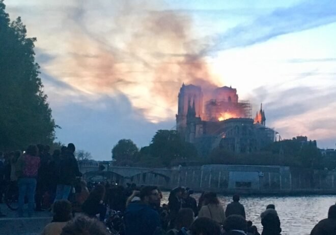 smoke and flames emitting from roof of Notre Dame