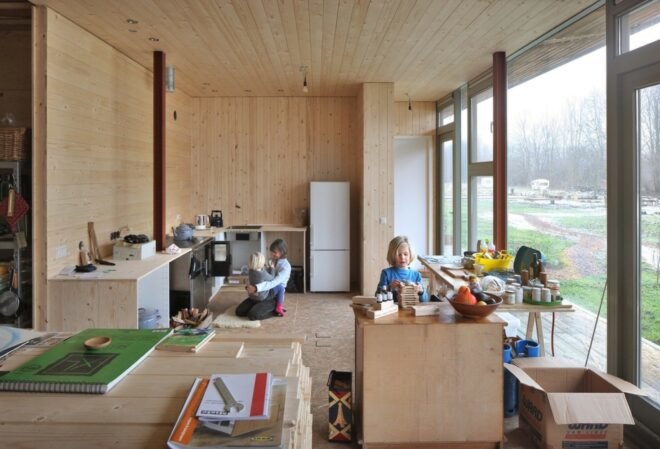 interior of home wooden home with large windows and kids playing