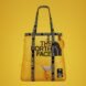 yellow bag with north face logo in front and black straps