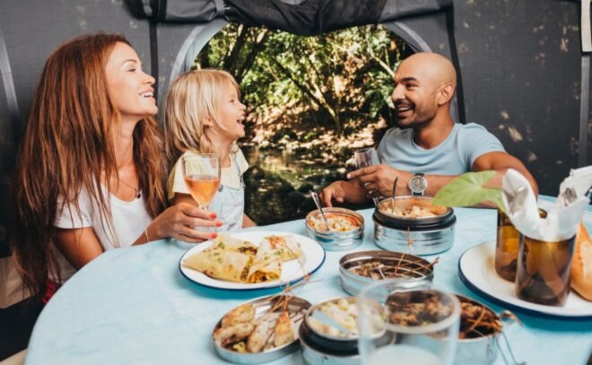 family eating dinner inside a tent