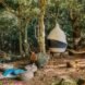 bean bags and hammock outside a tent in a forest