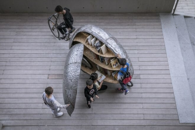aerial shot of metal contraption on wheels in the shape of a beetle