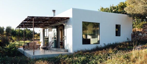 White, cube-like structure with front porch