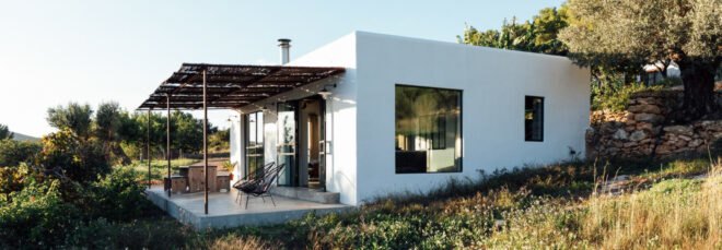White, cube-like structure with front porch