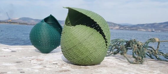 blue and green seashell sculptures on a rock by the sea