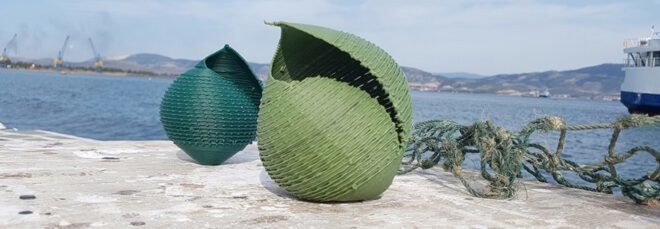 blue and green seashell sculptures on a rock by the sea