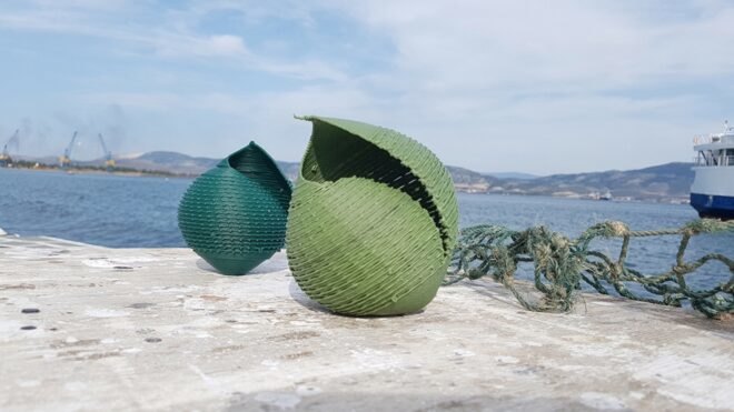 blue and green seashell sculptures on a rock by the sea