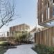 white stacked shipping containers with wood slat exteriors