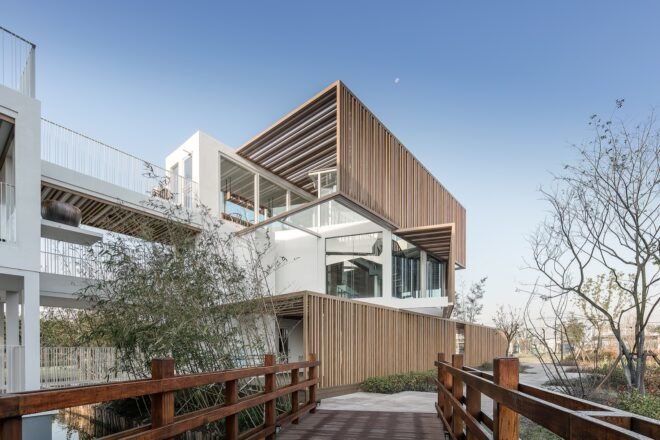wood walkway leading to stacked white shipping containers