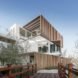 wood walkway leading to stacked white shipping containers