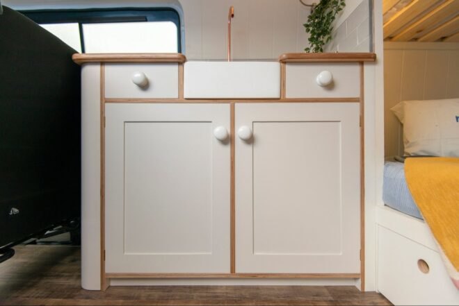 white kitchen cabinet with wood trim