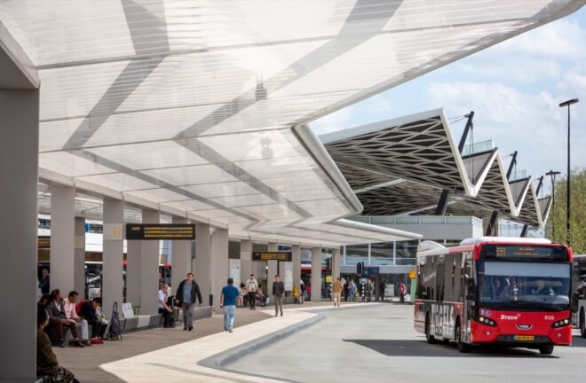 people walking around a solar-powered bus-station