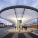 bus station with curved awning lit up at night