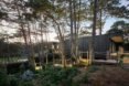 black timber home surrounded by trees