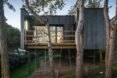 black timber home behind wooden walkway