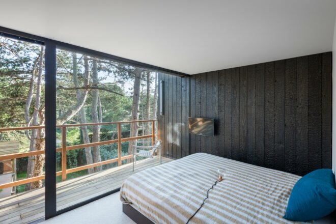 bedroom with striped comforter and large window