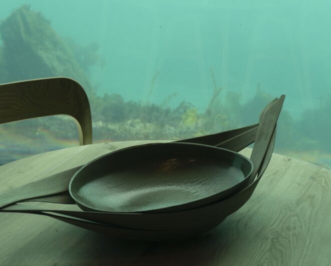 wood container holding a smooth brown serving bowl