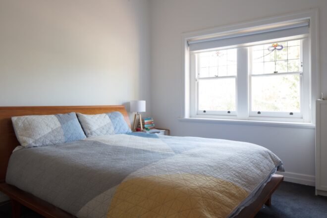 white bedroom with large windows