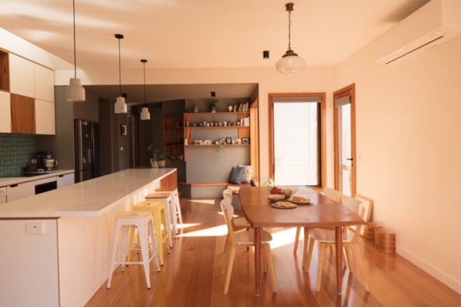 open kitchen and dining area with light wood accents
