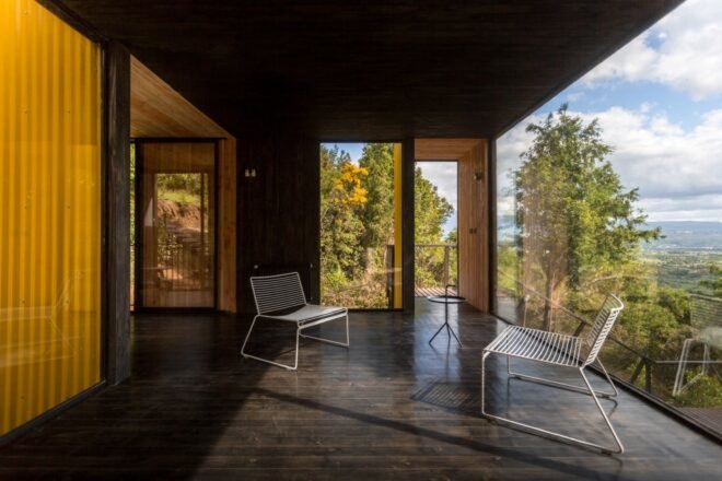 wood floors line the home along with wooden walls and large windows