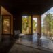 wood floors line the home along with wooden walls and large windows