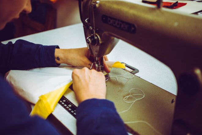 person sewing with a sewing machine