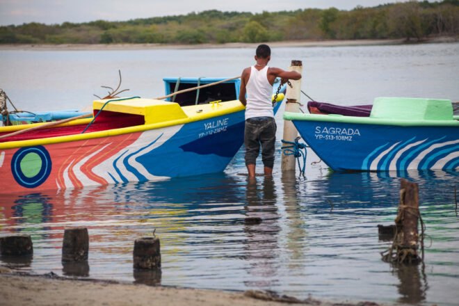 person docking a couple of colorful boats