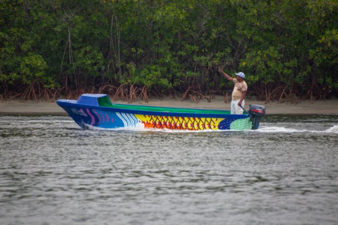person in colorful boat on water