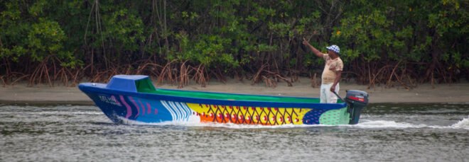 person in colorful boat on water
