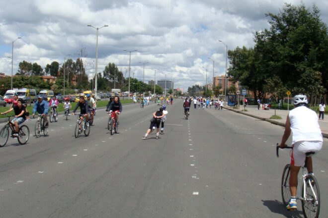 people biking and roller skating on a highway