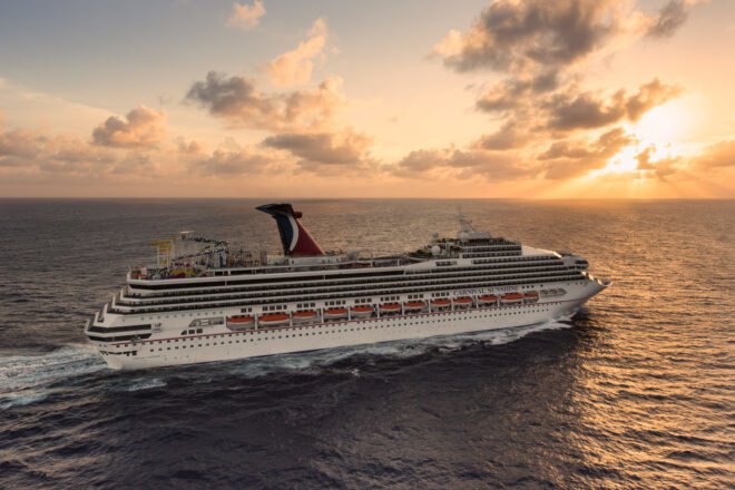 Carnival cruise ship on the ocean at sunset