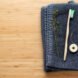 bamboo toothbrush and natural floss on blue washcloth