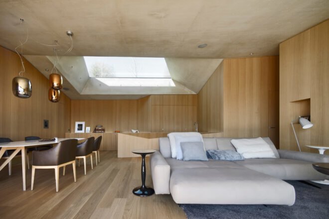 wood-lined interior with large beige couch