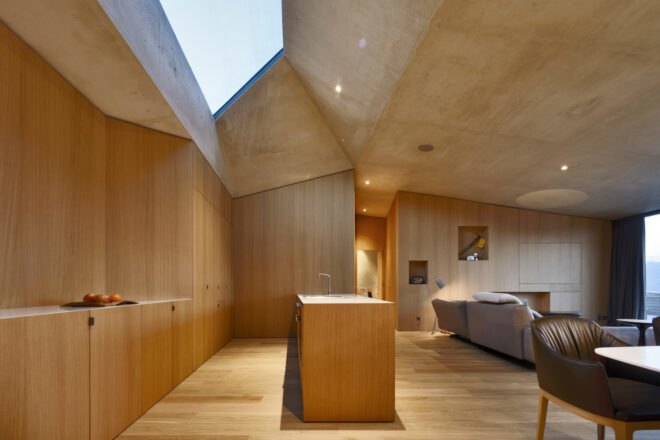 wood-lined interior with wood kitchen and large skylight