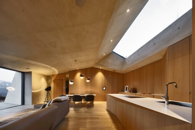 open-plan layout with wood kitchen island and beige sofa