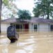 mailbox and home mostly submerged in flood waters