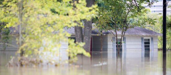 house mostly submerged in flood waters