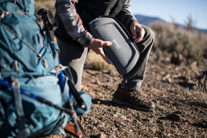 man unzipping a solar cooker