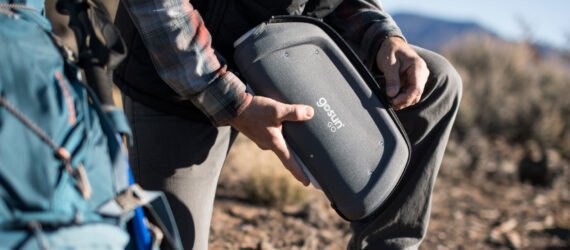 man unzipping a solar cooker