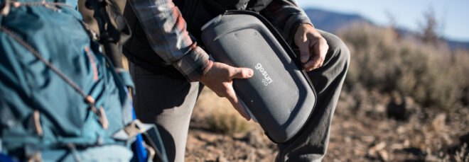 man unzipping a solar cooker