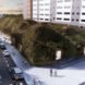 large elongated building covered in lush greenery