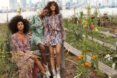 three models in dresses in a garden