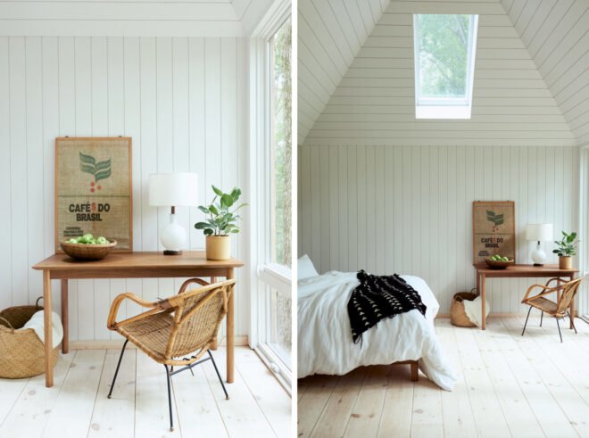 white bedroom with fluffy white bed, wood desk and a skylight