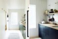 white kitchen with black cabinets and butcher block countertops