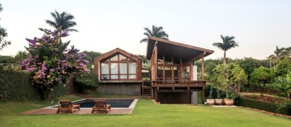 home with pitched roof and wooden deck