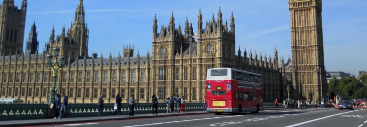double decker bus driving past parliament