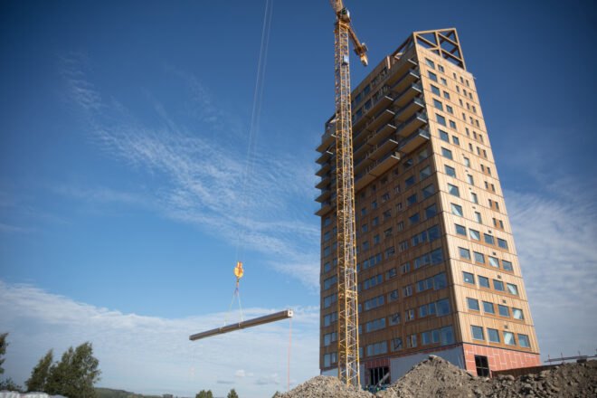 crane lifting wood beam into place